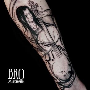 Violoncelliste aux cheveux longs tatoué par Bro Vanthorn